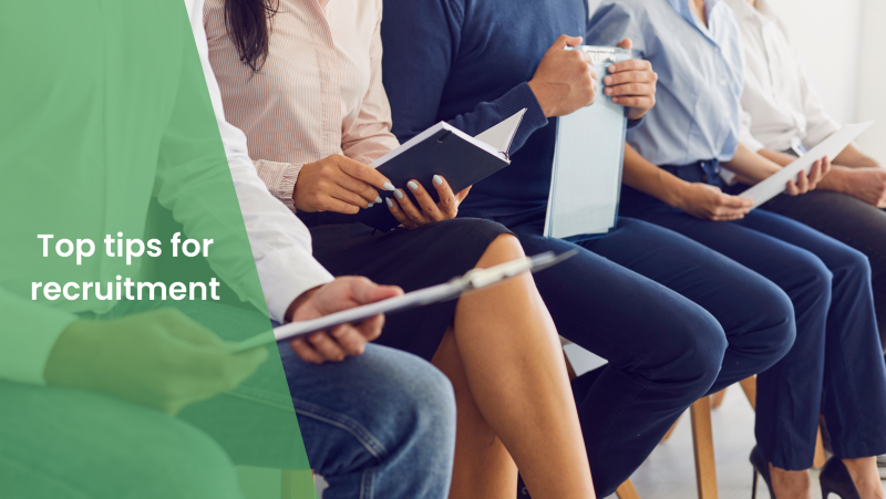 Image of people sitting on chairs waiting for an interview, an overlay of green background and the blog title "Top Tips for recruitment"