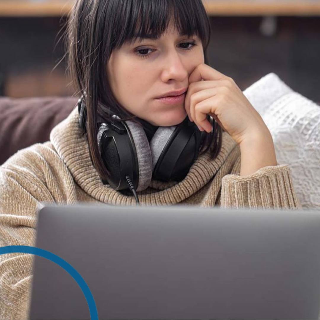 Woman looking worried at laptop