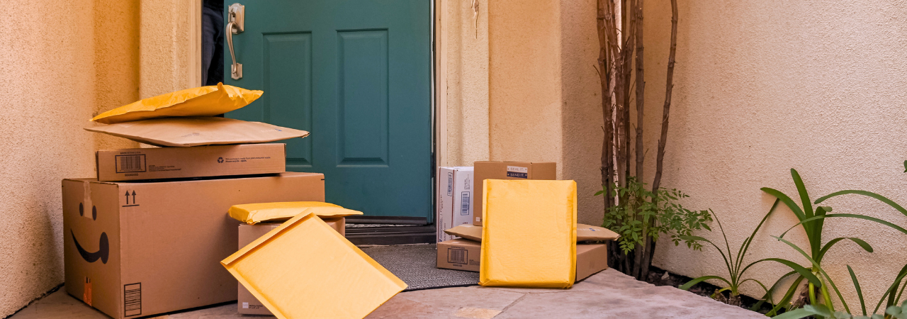 Pile of parcels sat outside green front door on the porch